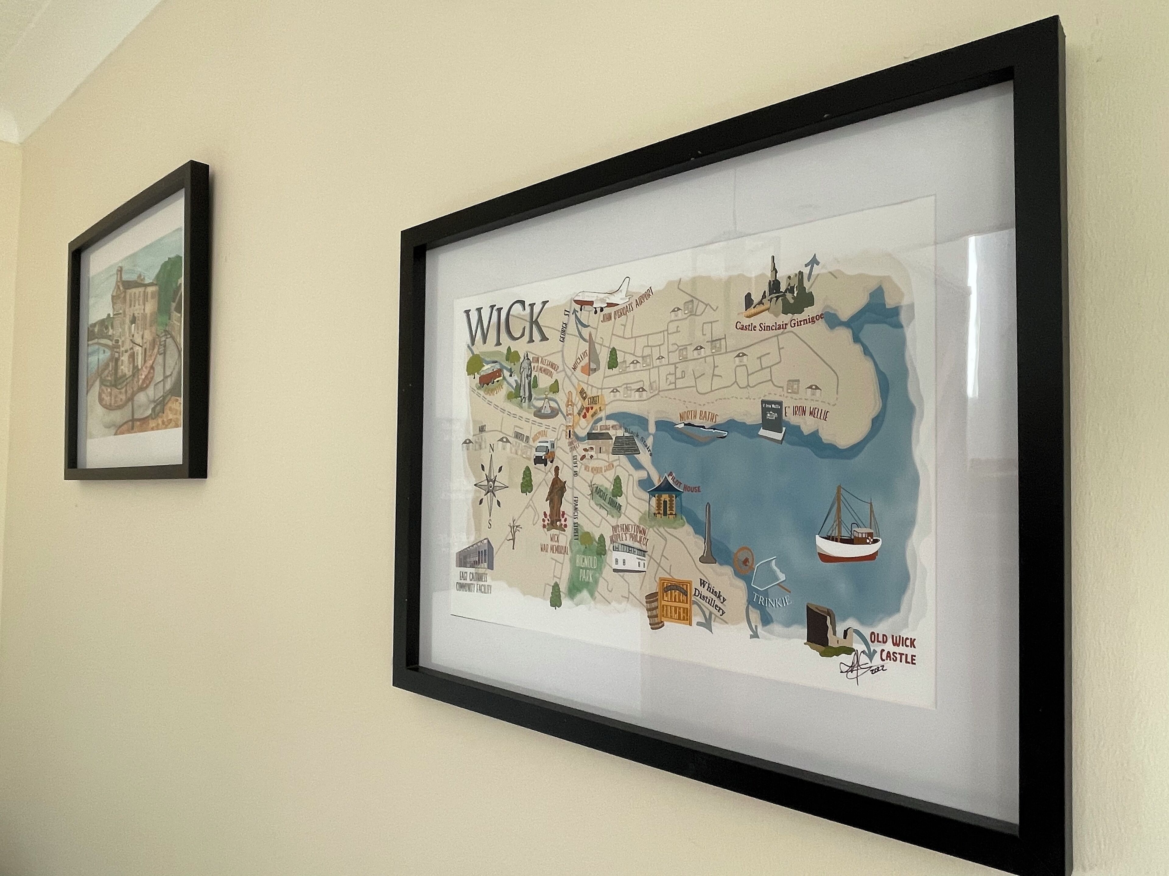 A framed map of Wick, Scotland, highlighting landmarks like Castle Sinclair Girnigoe and Old Wick Castle.