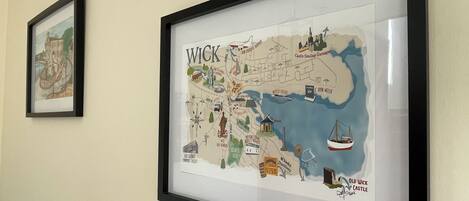 A framed map of Wick, Scotland, highlighting landmarks like Castle Sinclair Girnigoe and Old Wick Castle.