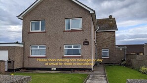 A two-story house with a brick exterior and multiple windows. - Broadhaven Road (Wick)