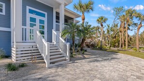 A two-story house with a covered porch and a paved driveway. - Sanibel Home ready for rentals ! (Sanibel)