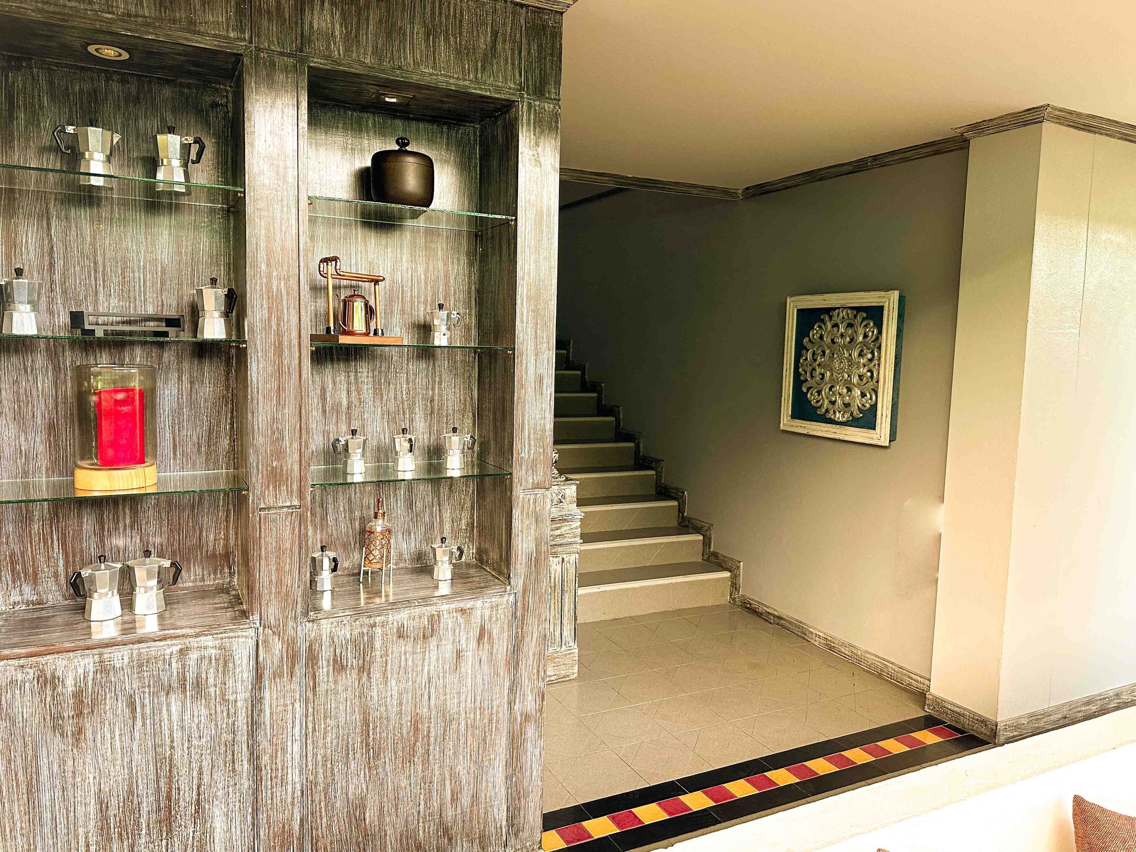 A staircase with a patterned carpet leading to a landing.