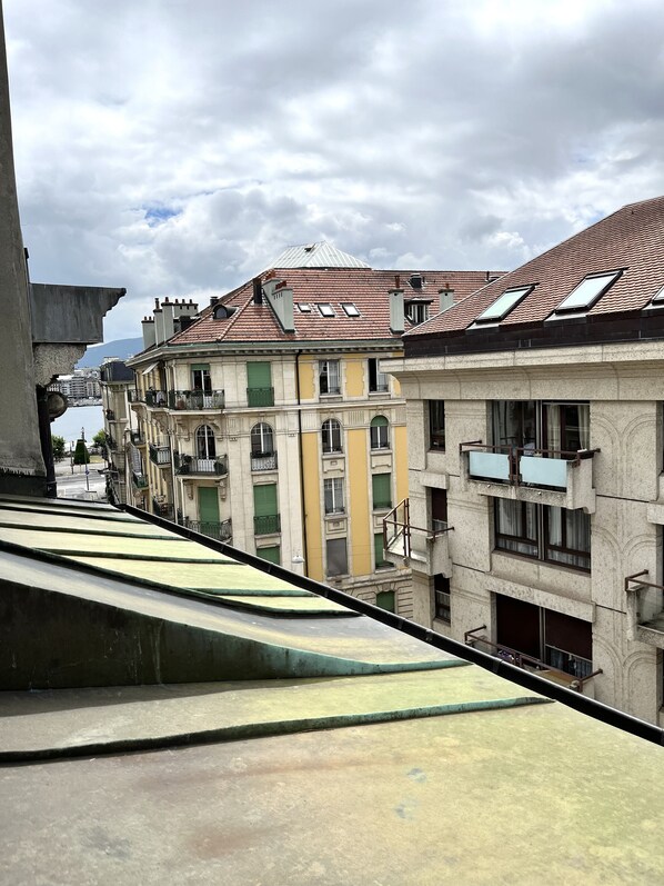 A row of buildings with a uniform architectural style, featuring balconies and a consistent roof design.