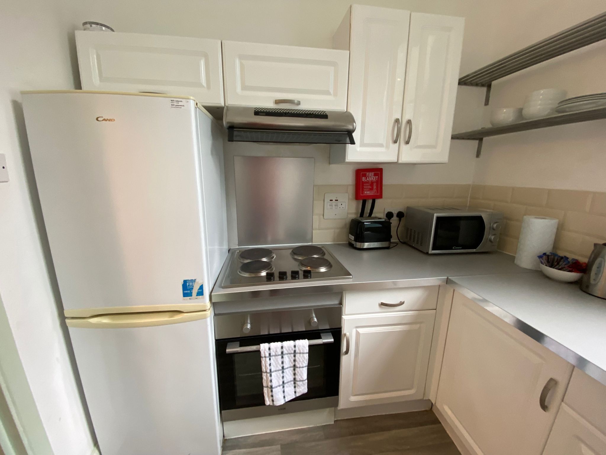 Fridge, oven, toaster, dining tables