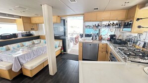 A compact kitchen with a stove, sink, and storage cabinets. - Cocoloco - Catamaran Lagoon 52F SAN BLAS (Narganá)