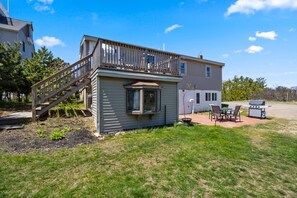 Enjoy a serene outdoor space with a patio area, grill, and comfortable seating.
