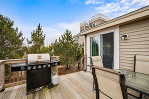 Enjoy al fresco dining on the deck with a barbecue grill and comfortable seating.