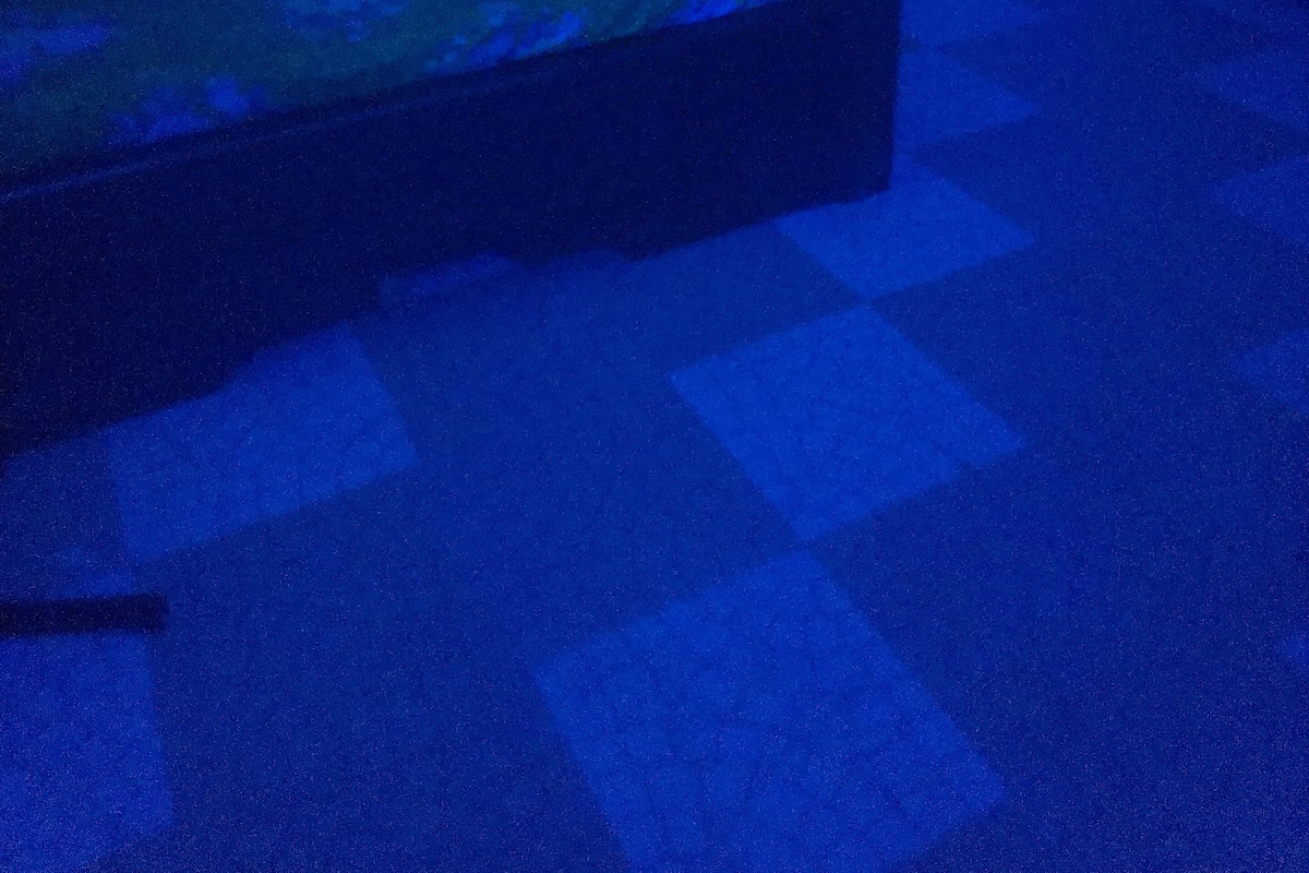 A room with a bed, a window, and a door.