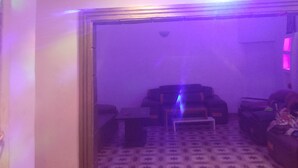 A room with a patterned carpet, a sofa, and a small table. - Jalupon Health Resort (Atan)