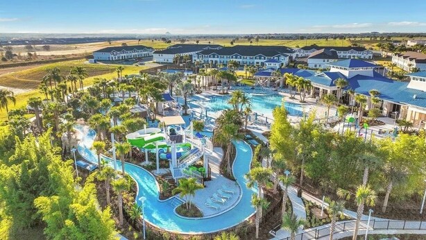 A resort with multiple swimming pools, a water park, and a large building complex.