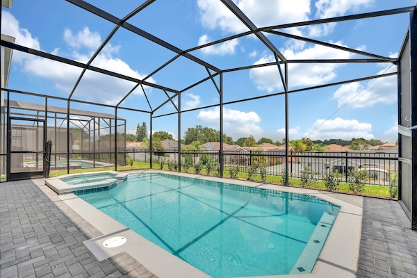 Your private pool and spa — no rear neighbors, just your group and the Florida sky.