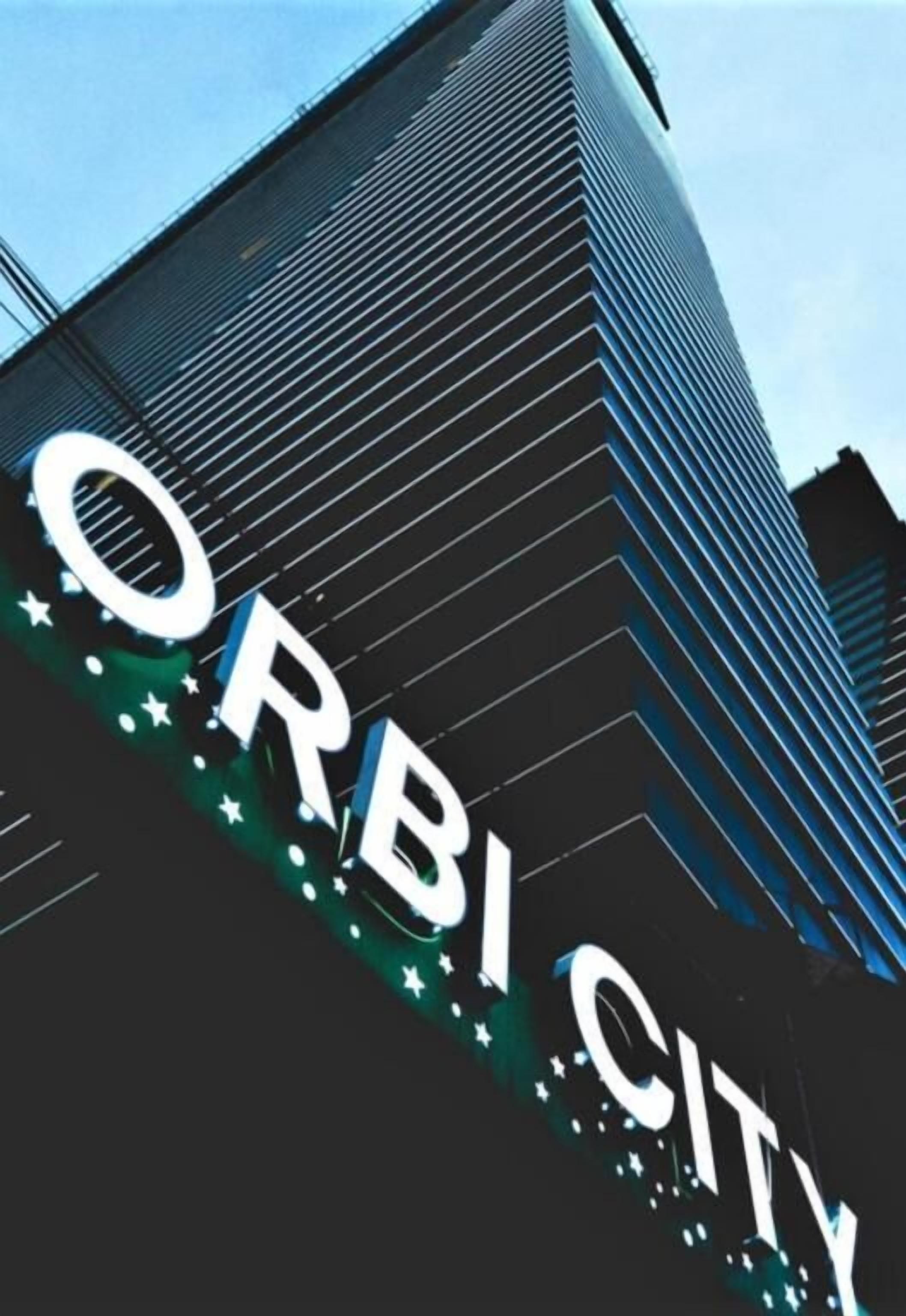 A building with the sign "ORBI CITY" prominently displayed.