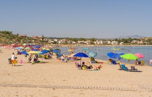 A beach with numerous colorful umbrellas and people relaxing on the sand. - Lovely home in Menfi with private swimming pool, can be inside or outside (Menfi)