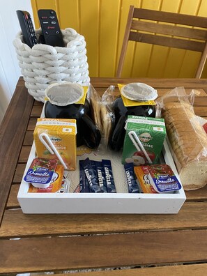 A tray with various food items and a remote control.