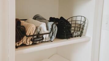 A storage shelf with labeled bins for 'STORAGE' and 'BATH'.