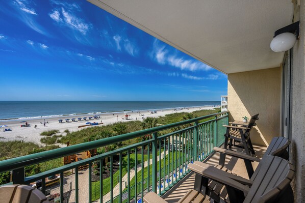 A balcony with a view of the beach, outdoor furniture, and a railing. - Windy Hill Dunes-Oceanfront 3BD-Family Friendly (North Myrtle Beach)