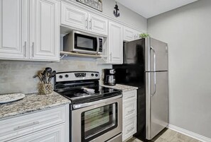 Enjoy cooking in this well-equipped kitchen with a microwave, refrigerator, and coffee maker.