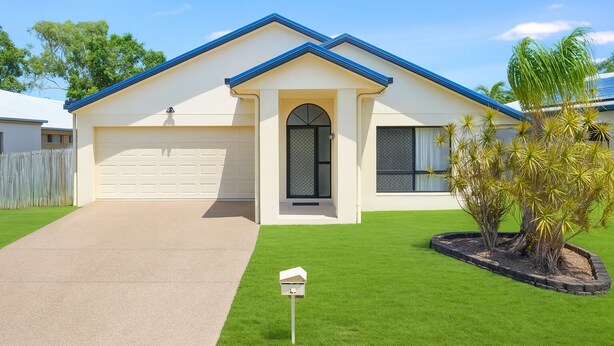 A single-story house with a garage, a front door, and a small front yard with a mailbox.