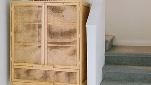 A rattan storage unit with a plant on top, positioned next to a staircase. - Hilltop Retreat w/ Lake & Mountain Views (Hope)