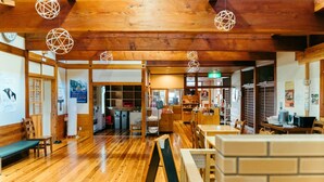 A traditional Japanese inn with wooden interiors, tatami mats, and a reception area. - Kiyokawa High-land Recreation Center (Aga)