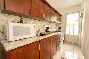 Fridge, microwave, stovetop, coffee/tea maker