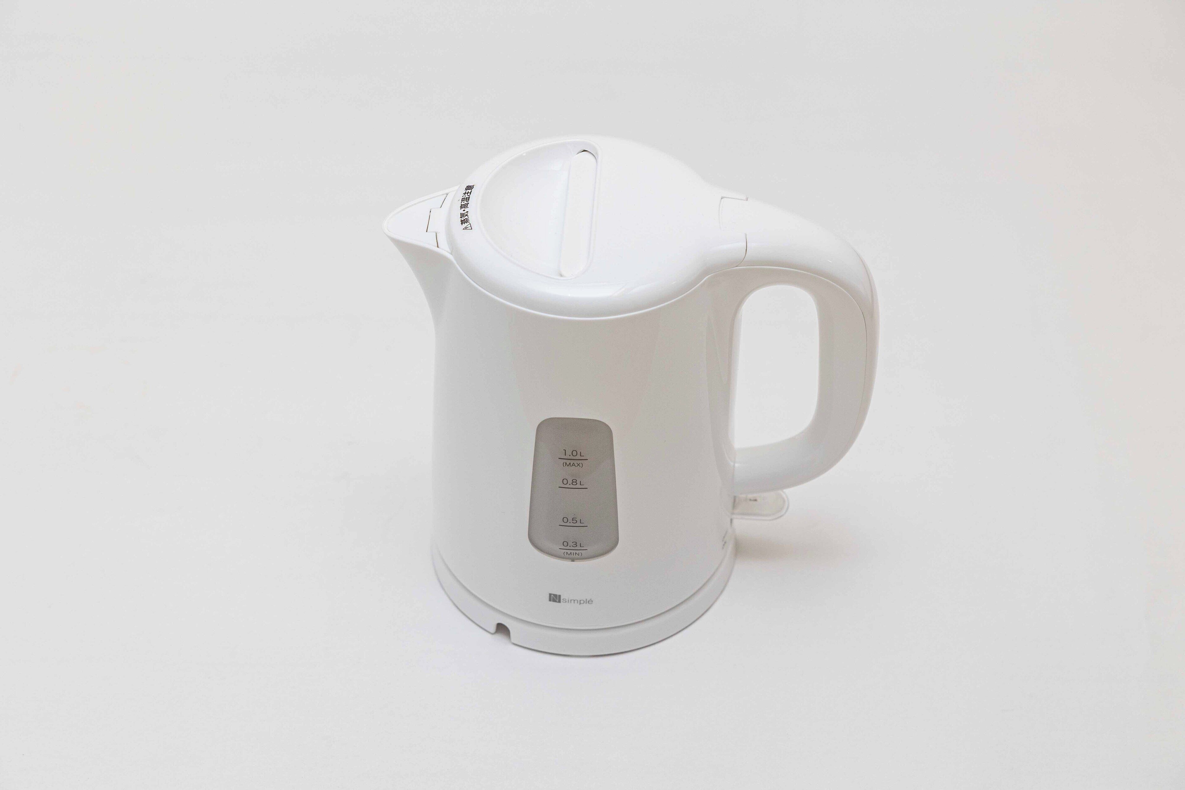 A white electric kettle with a handle and a spout, featuring a control panel with measurement markings.