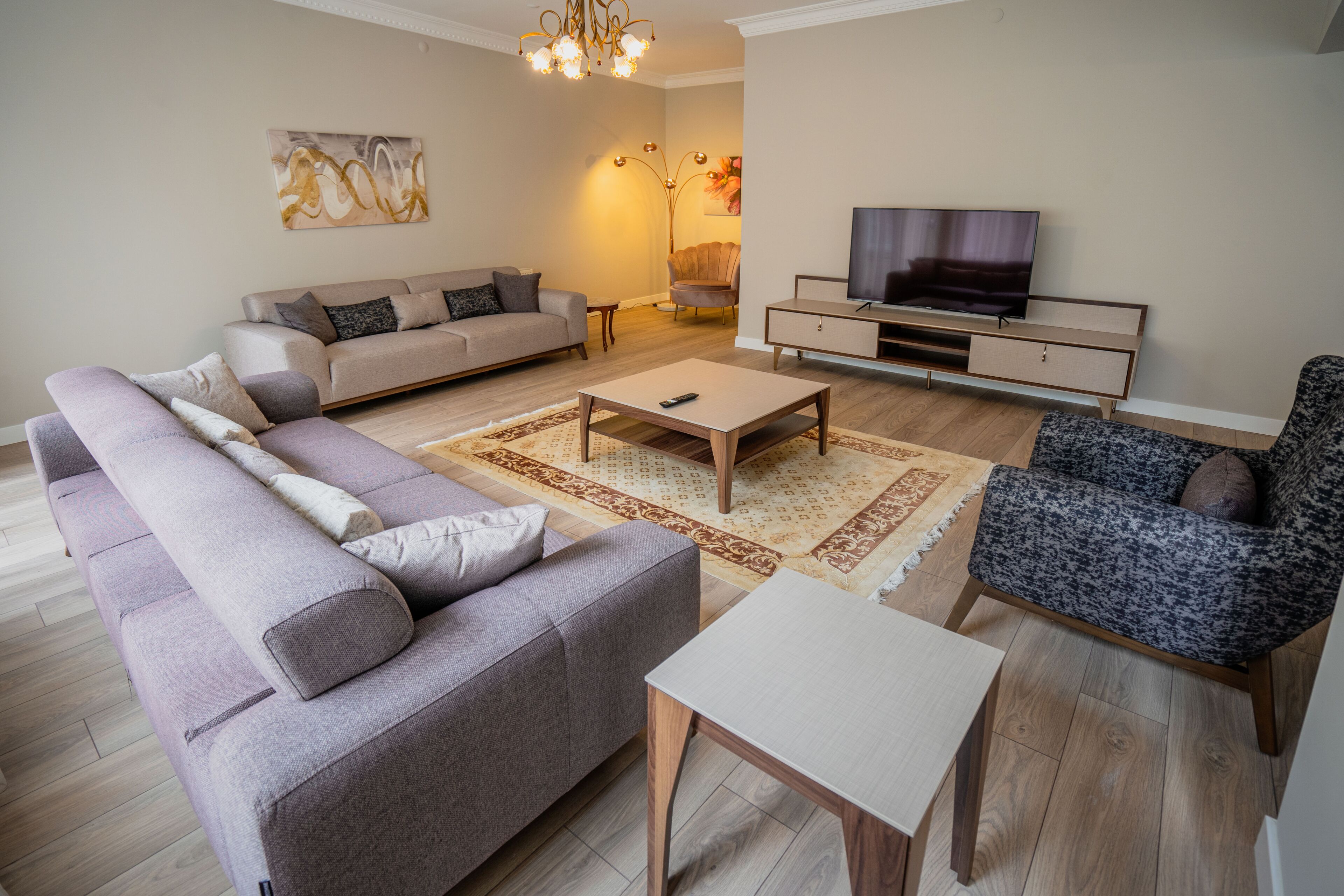 Elite Apartment, 4 Bedrooms, City View | Living area | 50-inch Smart TV with cable channels, TV