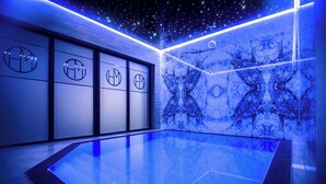 A modern indoor pool with a starry ceiling, marble walls, and a geometric floor design. - Mielno Hotel Boutique (Mielno)