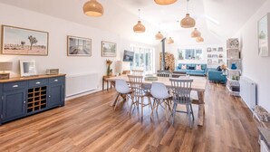 A spacious living area with a dining table, chairs, and a blue sofa. - Springfield, Westleton (Saxmundham)