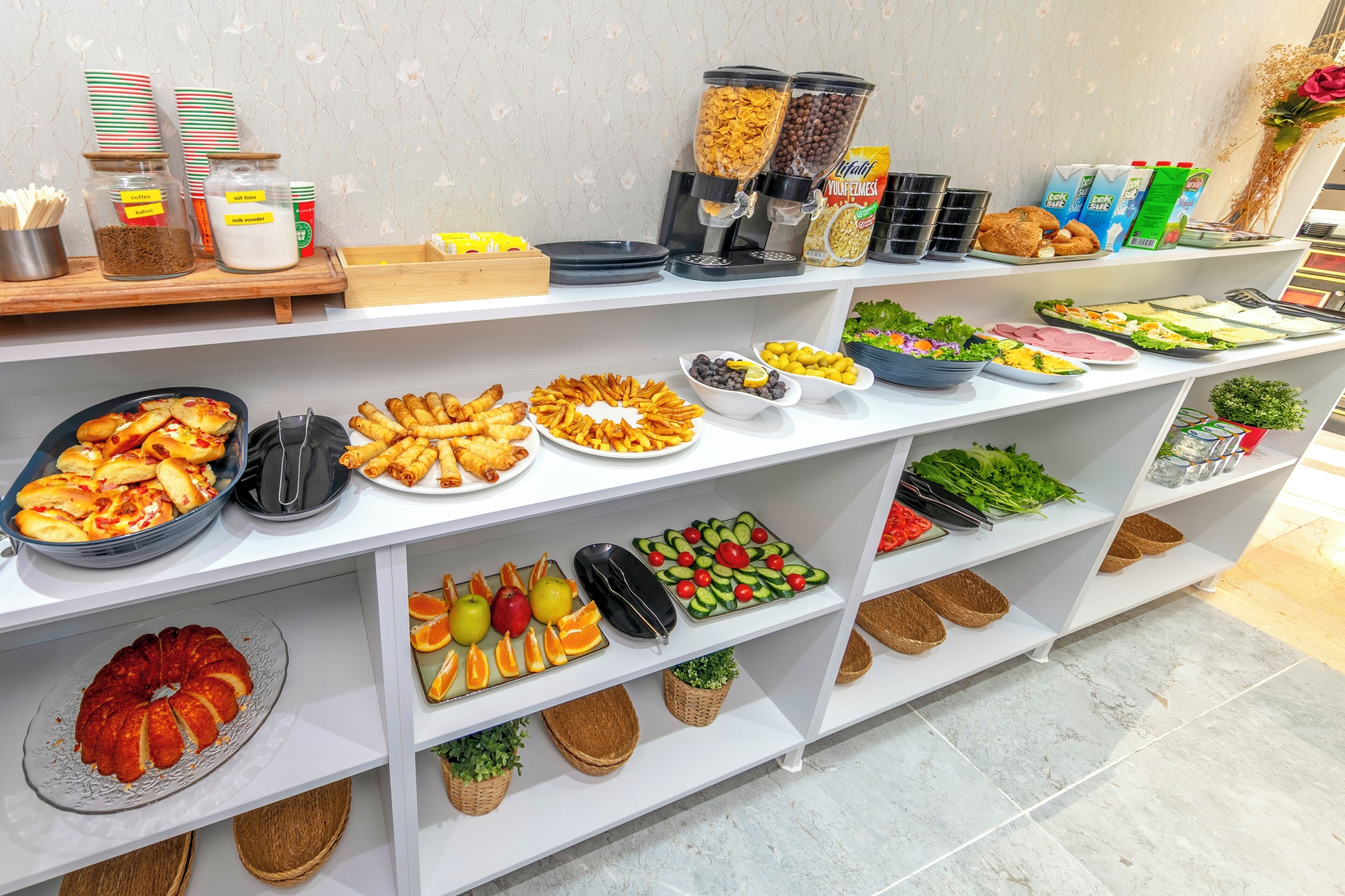 A buffet with various food items and beverages.