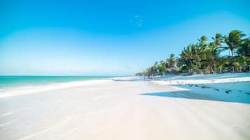 On the beach, sun loungers, beach towels, beach bar