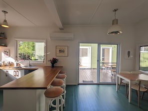 Enjoy cooking in this well-equipped kitchen with a large window offering a view of the outdoors.