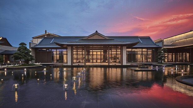A traditional building with a large entrance, a reflective pool, and a well-maintained garden. - Crowne Plaza Ganzhou by IHG (Ganzhou)