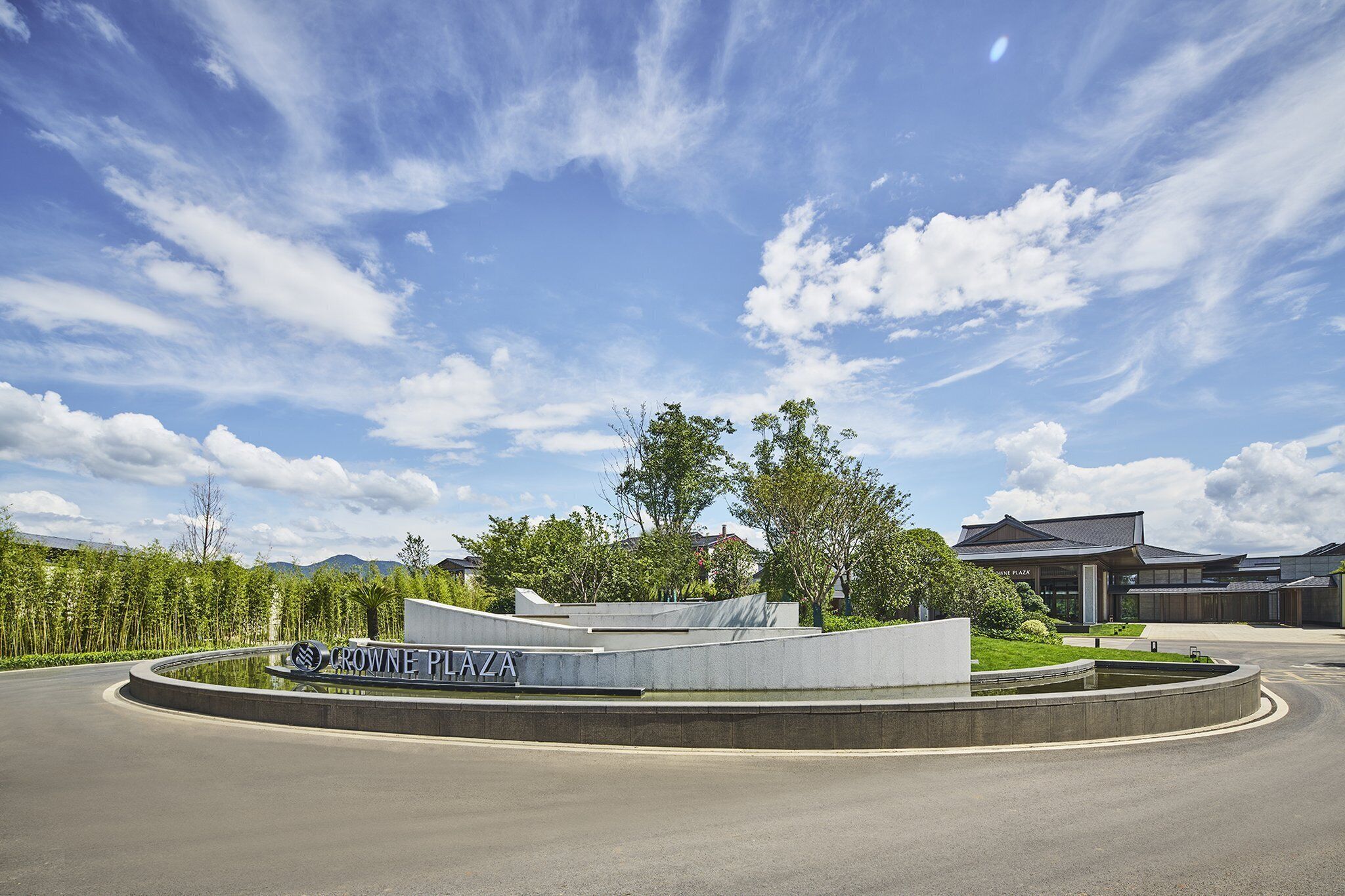A modern building with a sign reading "CROWNE PLAZA".