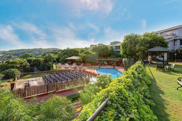 Outdoor pool, open 9:00 AM to 6:00 PM, pool umbrellas