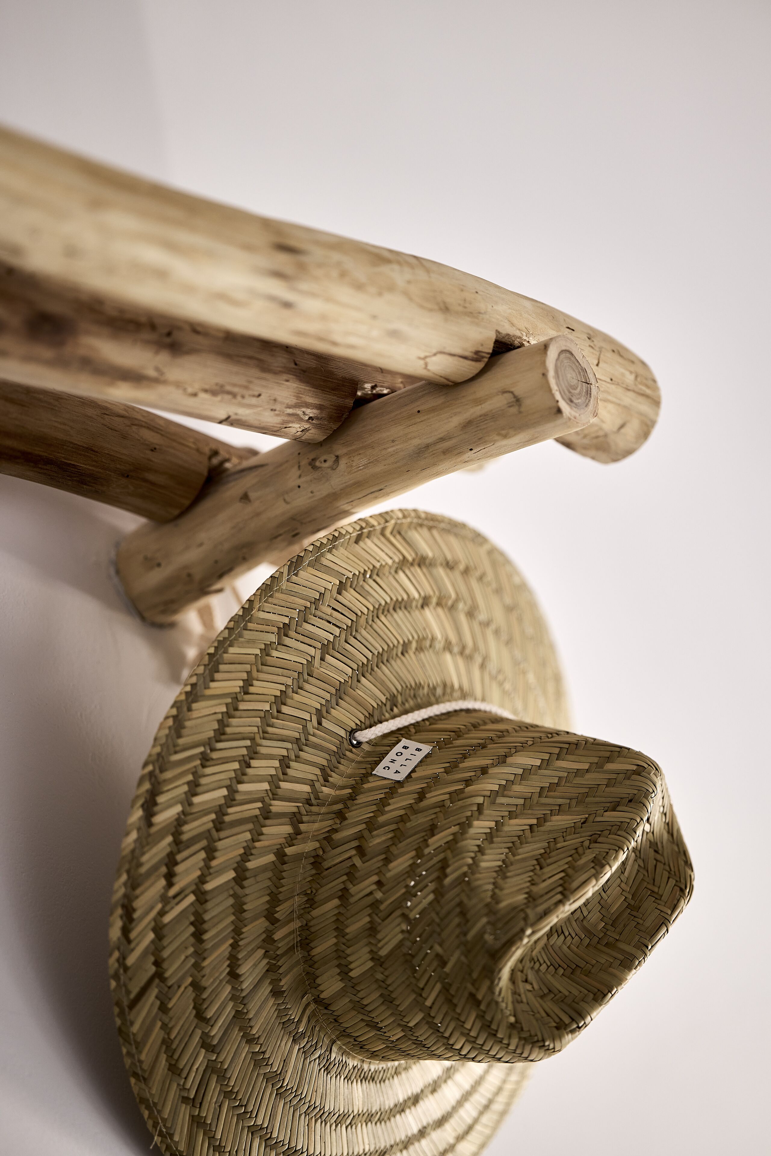 A woven basket with a tag, and a wooden structure with a circular cutout.