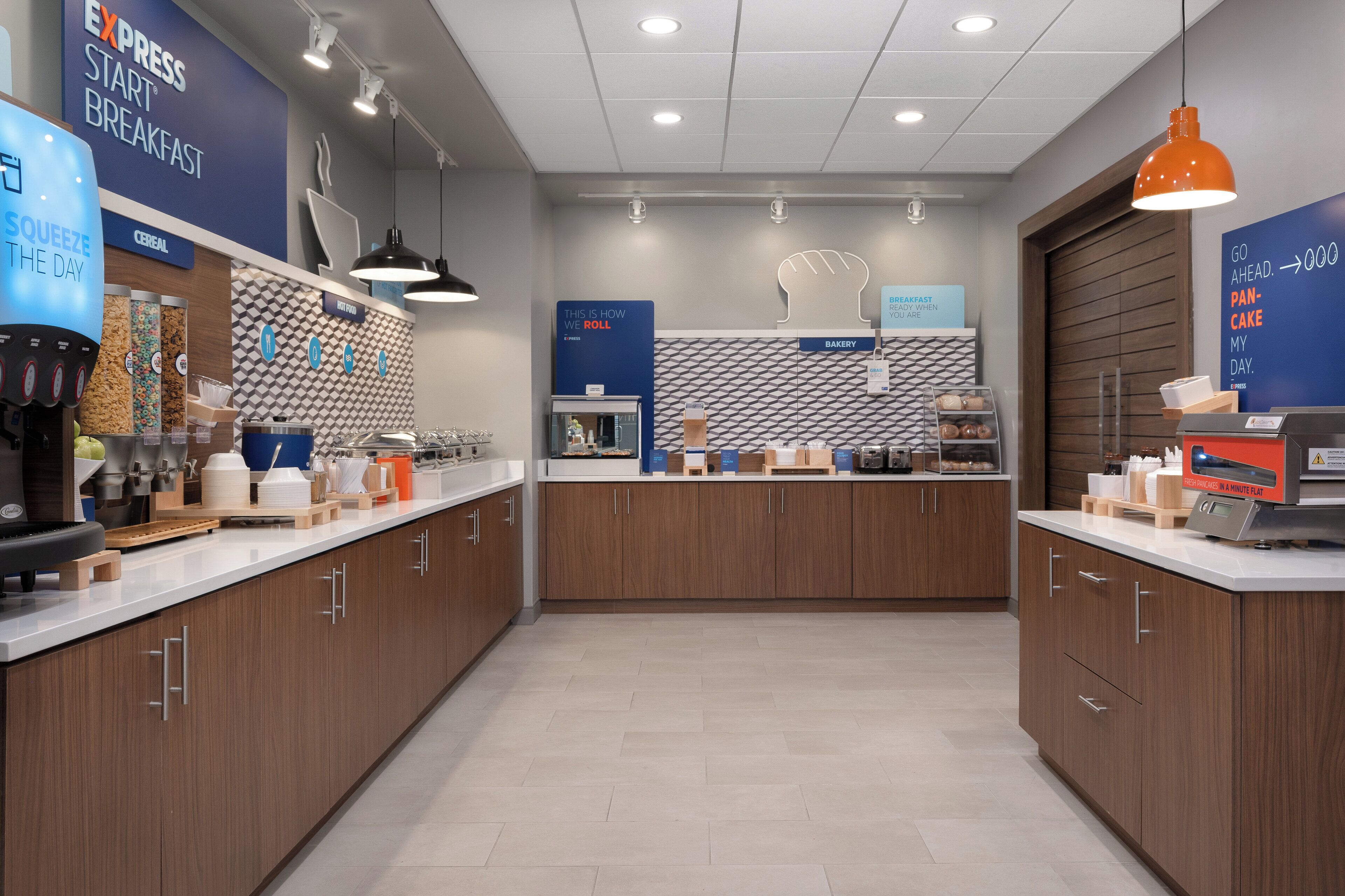 A modern kitchen area with a coffee machine, cereal dispensers, and a bakery section.