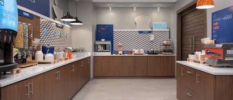 A modern kitchen area with a coffee machine, cereal dispensers, and a bakery section.