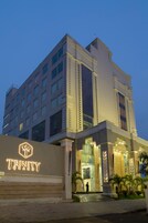 A modern hotel with a prominent entrance, large windows, and a well-lit facade.