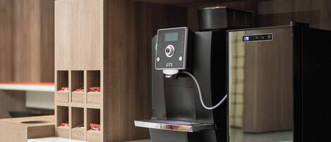 A coffee machine with a digital display and a water dispenser on a counter.