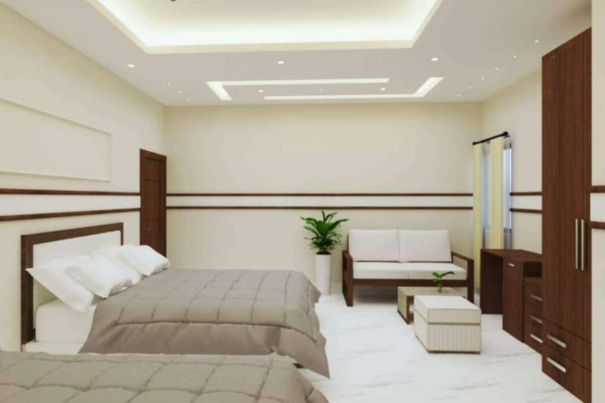 Un dormitorio moderno con cama, mesitas de noche, zona de estar y armario.