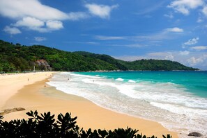 Guests can enjoy a serene beach experience with gentle waves lapping at the shore.