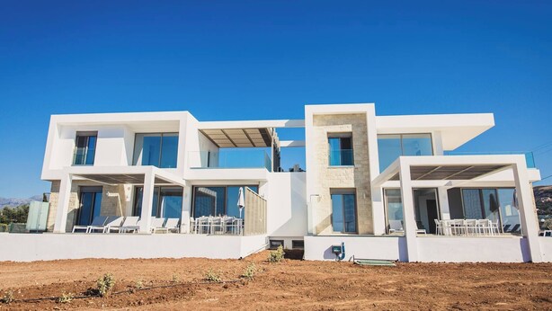 A modern two-story house with large windows, a balcony, and a flat roof. - Starlight Villas-8bd, Available For Events (Rethymno)