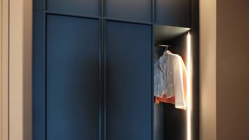 A modern closet with sliding doors and a hanging rack.