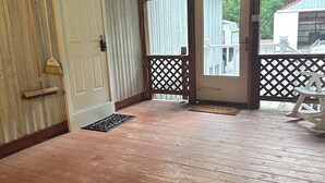 A wooden deck with a door leading to a covered porch. - Tranquil Quietness (Huntingdon)