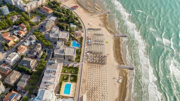 Enjoy stunning ocean views from this beachfront hotel, surrounded by lush greenery and a large pool.
