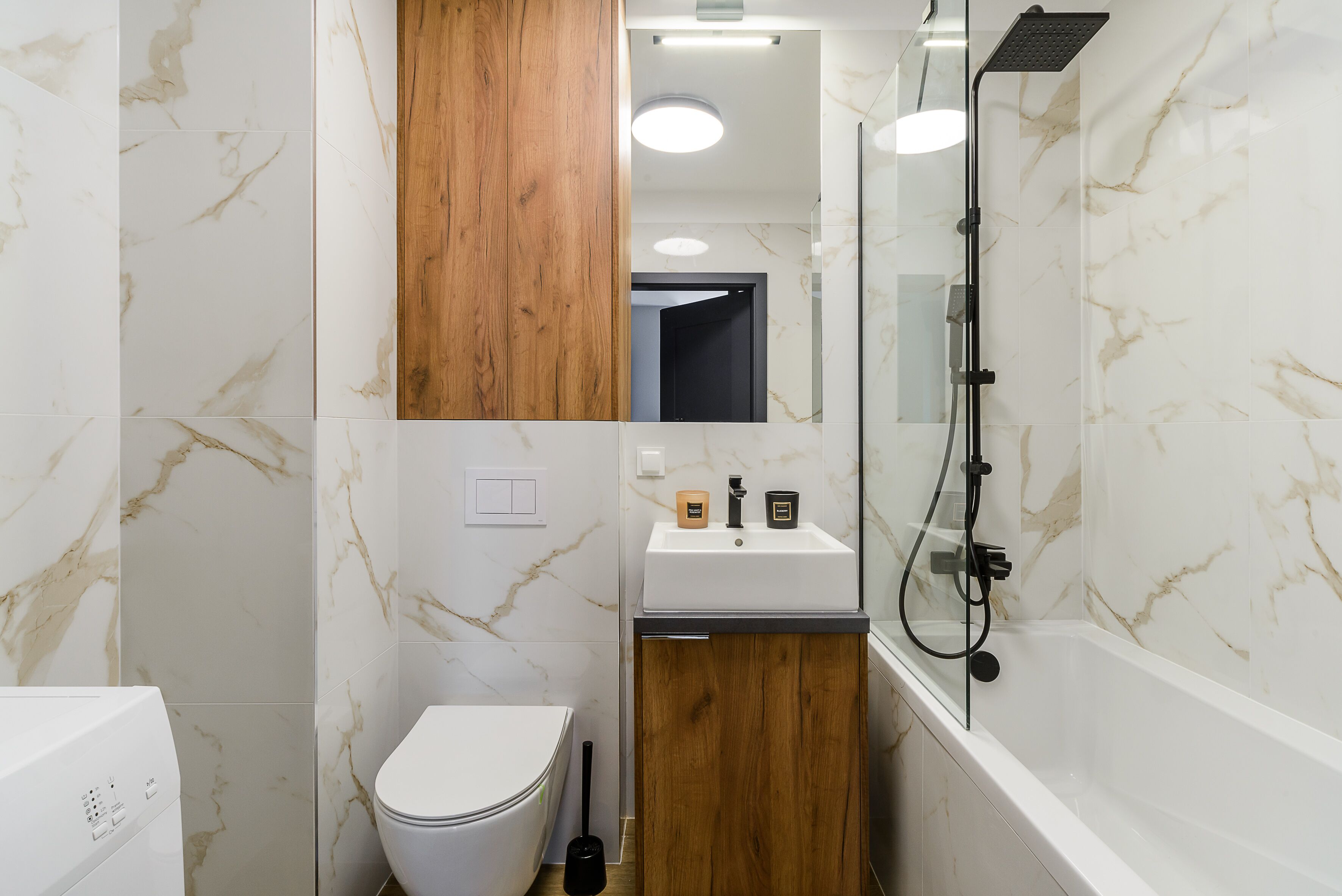 A bathroom with a toilet, sink, and shower.