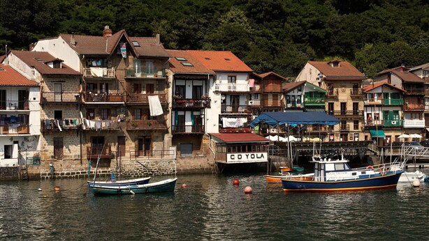 A waterfront with traditional buildings, a dock with boats, and a sign reading "CD YOLA". - COMFORTABLE AND BRAND NEW APARTMENT (Zarautz)