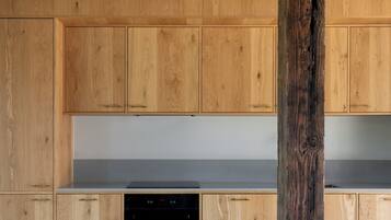 A modern kitchen with wooden cabinetry and a central island.