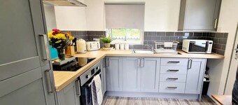 Hillside Hideaway chalet with swimming pool, play area, fishing lake.