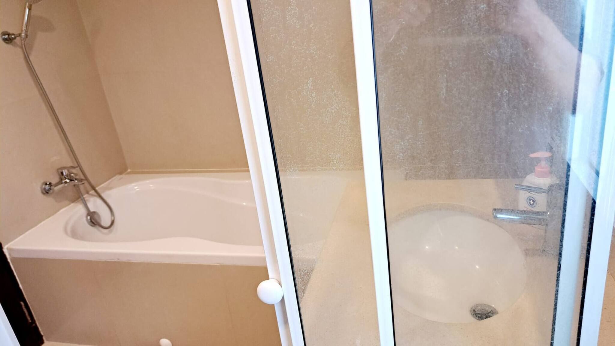 A bathroom with a bathtub, a toilet, and a shower.